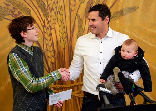BORIS MINKEVICH / WINNIPEG FREE PRESS
For the fifth straight year Atticus McIlraith presented an accumulation of baby formula, cash, cheques and coupons to Winnipeg Harvest. McIlraith was the recipient of the 2017 Outstanding Youth in Philanthropy (Under 15) at the Manitoba Philanthropy Awards ceremony held this past November. He started the Atticus McIlraith Baby Formula Drive when he was 10 years old and his efforts have raised thousands of dollars worth of infant formula and cash donations to making sure no infant goes hungry here in Winnipeg. From left, Atticus McIlraith gets a cheque from Judy Lindsay Team Realty's Allan Asplin and his 8 month old William. January 17, 2018