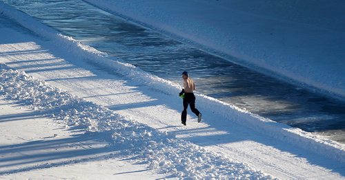 PHIL HOSSACK / Winnipeg Free Press - A shirtless man jogs enjoying the warm sun as Winnipeggers gather on the newest part of the River trail wednesday as it winds all the way around Armstrong Point to the Sherbrook/Maryland street Bridges. Crews appear to be prepping to extend the trail further west from there. -  January 17, 2018