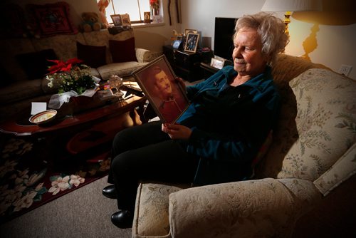 JOHN WOODS / WINNIPEG FREE PRESS
Rose Onofrey, mother of RCMP officer Dennis Onofrey, who was shot to death in Virden 40 years ago, looks at family photographs in her home Tuesday, January 16, 2018. Dennis Onofrey was killed January 23, 1978 during a standoff in Virden, Manitoba. He was 27.