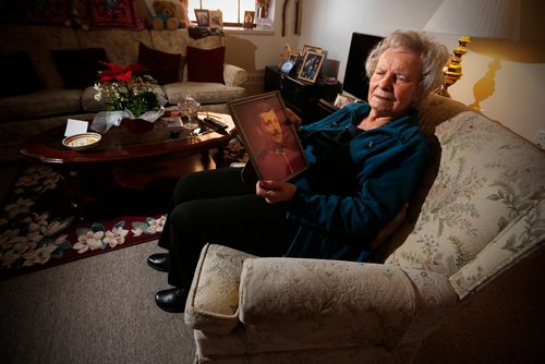 JOHN WOODS / WINNIPEG FREE PRESS
Rose Onofrey, mother of RCMP officer Dennis Onofrey, who was shot to death in Virden 40 years ago, looks at family photographs in her home Tuesday, January 16, 2018. Dennis Onofrey was killed January 23, 1978 during a standoff in Virden, Manitoba. He was 27.