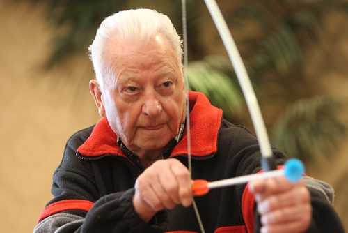 RUTH BONNEVILLE / WINNIPEG FREE PRESS

Residences of Shaftesbury Park take part in various activities Thursday like archery and zumba class during Spirit Week in preparation of the  9TH ANNUAL asc SENIORS GAMES

Robert Rolfe who loves to be funny, tries his hand at archery Thursday.  
 
Canada Seniors Games (February 5th - 9th, 2018), is when thousands of seniors will enjoy an environment of friendly competition while staying healthy and having fun during the winter months at 29 All Seniors Care Living Centres across Canada.
 
Standup photo 

Jan 18, 2018
