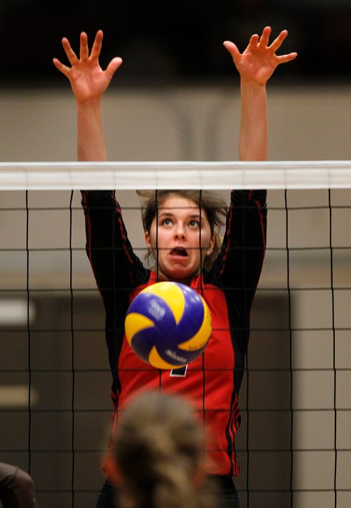 PHIL HOSSACK / Winnipeg Free Press - Wesmen #4 Taylor Boughton grimaces as she blocks a spike from crosstown rivals U of M Bisons Thursday night in the 27th annual Duckworth Challenge. STAND-UP  - January 18, 2018