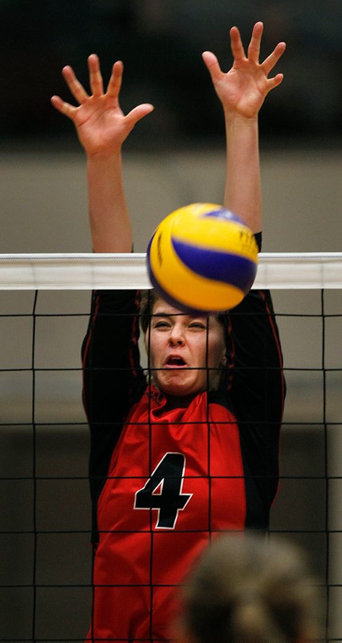 PHIL HOSSACK / Winnipeg Free Press - Wesmen #4 Taylor Boughton grimaces as she blocks a spike from crosstown rivals U of M Bisons Thursday night in the 27th annual Duckworth Challenge. STAND-UP  - January 18, 2018