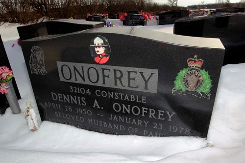 BORIS MINKEVICH / WINNIPEG FREE PRESS
Const. Dennis Onofrey is buried in the Assumption Roman Catholic Cemetery on the west end of the city. The grave marker has a photo of Onofrey, an etching of the RCMP regimental badge with another of Jesus, and his dates of birth and death. Here is the head stone. January 19, 2018