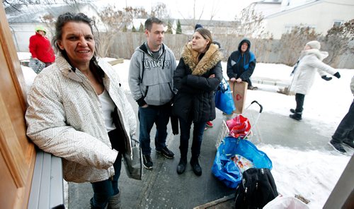 PHIL HOSSACK / Winnipeg Free Press - Angie Guiboche waits for the door to open with other locals who frequent the Euclid Ave Food Bank at Barber House Friday. Jamie Brenner and his partner Tara Haddad wait next to her, they have 5 kids at home and use the food bank to make ends meet. See Nick Martin story re: Funding Cuts. -  January 19, 2018