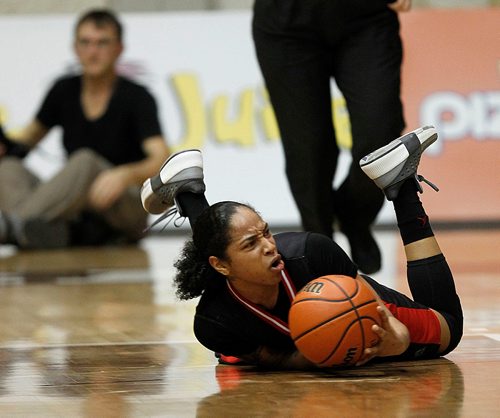 PHIL HOSSACK / Winnipeg Free Press -  U of W #1 Antoinette Miller reacts to a U of W foul that left her sprawled and sliding across the floor Friday at Investor's Group Athletic Centre. -  January 19, 2018