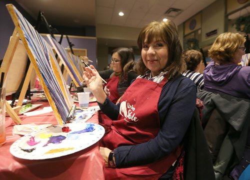 Linda Webb works on her painting at Urban Stable's paint party fundraiser on Jan. 18, 2018 at Triple B's Bar and Billiards on Scurfield Boulevard. (See Social Page)