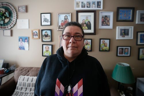 JOHN WOODS / WINNIPEG FREE PRESS
Mary Burton, who works to empower people who are in the Child and Family Services (CFS) system, is photographed in front of her family "wall of fame" in her Winnipeg home Sunday, January 21, 2018. Burton co-founded Fearless R2W three years ago,  which supports CFS clients and is named after the North End postal code frequently visited by Child and Family Services agents.