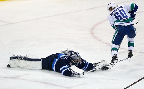JOHN WOODS / WINNIPEG FREE PRESS
Winnipeg Jets goaltender Connor Hellebuyck (37) dives to stop the breakaway attempt by Vancouver Canucks' Markus Granlund (60) during third period NHL action in Winnipeg on Sunday, January 21, 2018.