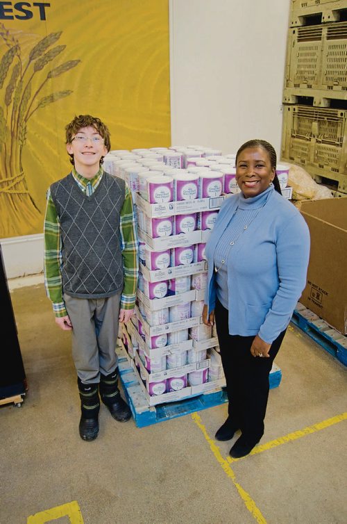 Canstar Community News Jan. 24, 2018 - Atticus McIlraith, 14, is pictured with Winnipeg Harvest executive director Keren Taylor-Hughes after presenting a $30,305 donation of baby formula, cash, and coupons on Jan. 17. (DANIELLE DA SILVA/SOUWESTER/CANSTAR)