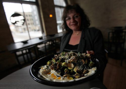 PHIL HOSSACK / Winnipeg Free Press -  Roula Alevizos holds up a large plate of  Brussels Sprouts At the Saddlery on Market. See Sanderson's story.  -  January 23, 2018