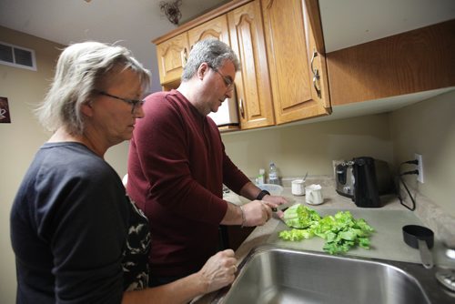 RUTH BONNEVILLE / WINNIPEG FREE PRESS

Feature:  Lewy Body dementia 
Photos at home of Sandy and her husband Doug McLean , 61, who has Lewy Body dementia (first noticed changes in his mid-50s). They are still living together and use home care services. 
Sandy helps Doug in kitchen. 
See Carol Sanders  | Reporter 


Jan 23, 2018
