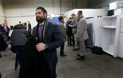 PHIL HOSSACK / Winnipeg Free Press -  Tom Thiessen, Executive Director of the Building Owners and Managers Association, puts on his coat and leaves a press conference after an announcement by Crown Services Minister Cliff Cullen Wednesday morning. See Nick Martin's story.  -  January 20, 2018