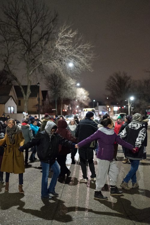 Daniel Crump / Winnipeg Free Press. Attendees of the vigil for Claudette Osborne-Tyo take part in a round dance that temporarily shuts down Selkirk Avenue. January 24, 2018.