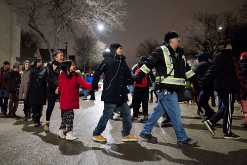 Daniel Crump / Winnipeg Free Press. Attendees of the vigil for Claudette Osborne-Tyo take part in a round dance that temporarily shuts down Selkirk Avenue. January 24, 2018.