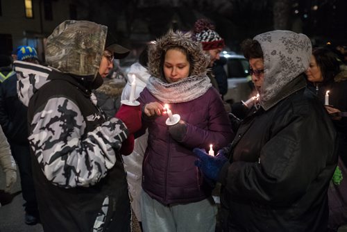 Daniel Crump / Winnipeg Free Press. Attendees of the vigil for Claudette Osborne-Tyo light candles. January 24, 2018.