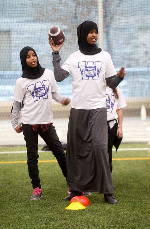 PHIL HOSSACK / Winnipeg Free Press - STAND-UP - 10 yr old Bushra Abtidoon a Dufferin School student, prepares to pass the ball at an afterschool football camp held at the U of W Thursday afternoon. Sponsored by city police and the Blue Bombers about 200 kids assembled Winnipeg Axworthy Health and RecPlex.  See release. -  January 25, 2018

WINNIPEG, MB., January 25, 2018  The Winnipeg Blue Bombers and the Winnipeg Police Association (in partnership with the University of Winnipeg, Sport Manitoba, Canadian Tire Jumpstart Charities, and Spence Neighbourhood Association), will kick-off the 2018 Winnipeg Youth Football Club, an after-school flag football program for youth in downtown Winnipeg.

Each week, more than 200 youth from 10 different schools and organizations in Winnipegs central area will receive free certified flag football coaching for 90 minutes, dinner, t-shirts, and school bus transportation to and from the club, which takes place at the University of Winnipeg Axworthy Health & Recplex.

To celebrate the first week of the camp, Winnipeg Blue Bombers offensive lineman Matthias Goossen and linebacker Thomas Miles will guest coach and will be mentors to the participants.

The Blue Bombers are committed to supporting flag and tackle football at all levels, said Wade Miller, President & CEO of the Winnipeg Blue Bombers. Were proud to work with our partners to provide youth with a safe and fun after-school program where they can learn flag football fundamentals and stay active.

This is the fifth year of the program and the second year the Winnipeg Police Association (WPA) has been the presenting partner.

Both the Winnipeg Police Association and the Winnipeg Blue Bombers have long, successful histories supporting youth in the community, said Maurice Sabourin, President, WPA. The WPA is proud to be the presenting sponsor of the Winnipeg Youth Football Club and we look forward to continuing to connect and work with inner-city youth.