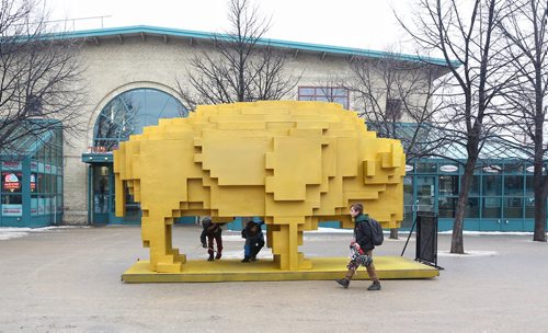 MIKE DEAL / WINNIPEG FREE PRESS
Pedestrians check out one of the winning submissions to this years warming huts competition at The Forks. The Golden Bison designed by David Alberto Arroyo Tafolla who is an architect from Mexico. 
180126 - Friday, January 26, 2018