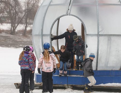 MIKE DEAL / WINNIPEG FREE PRESS
Kids check out one of last years warming huts titled "Greetings From Bubble Beach" while skating on the Red River at The Forks. 
180126 - Friday, January 26, 2018.