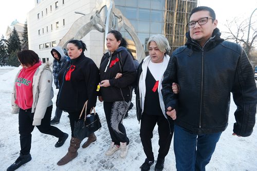 JOHN WOODS / WINNIPEG FREE PRESS
Thelma Favel (2nd R) and Brian Favel (R), Tina Fontaine's aunt and uncle, leave the law courts with unidentified family members after the first day of testimony in the 2nd degree murder trial of Raymond Cormier, Fontaine's alleged killer, in Winnipeg Monday, January 29, 2018.