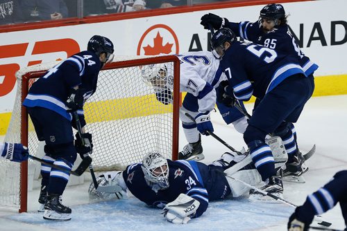 JOHN WOODS / WINNIPEG FREE PRESS
Winnipeg Jets Michael Hutchinson (34) makes the save against Tampa Bay Lightning's Yanni Gourde (37) as Jets' Josh Morrissey (44), Tyler Myers (57) and Mathieu Perreault (85) defend during first period NHL action in Winnipeg on Tuesday, January 30, 2018.