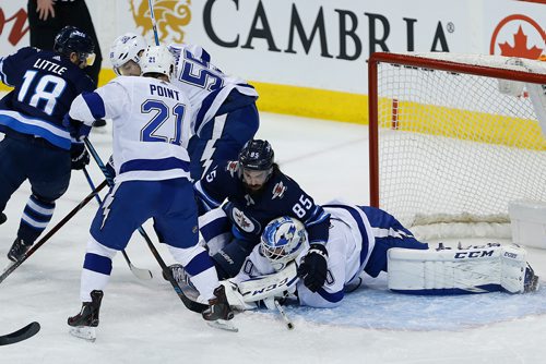 JOHN WOODS / WINNIPEG FREE PRESS
Winnipeg Jets' Mathieu Perreault (85) lands on Tampa Bay Lightning's goaltender Louis Domingue (70) as he makes the save during first period NHL action in Winnipeg on Tuesday, January 30, 2018.