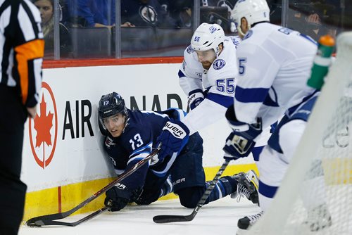 JOHN WOODS / WINNIPEG FREE PRESS
Winnipeg Jets' Brandon Tanev (13) reaches out for the loose puck after getting dumped by Tampa Bay Lightning's Braydon Coburn (55) and Dan Girardi (5) during second period NHL action in Winnipeg on Tuesday, January 30, 2018.