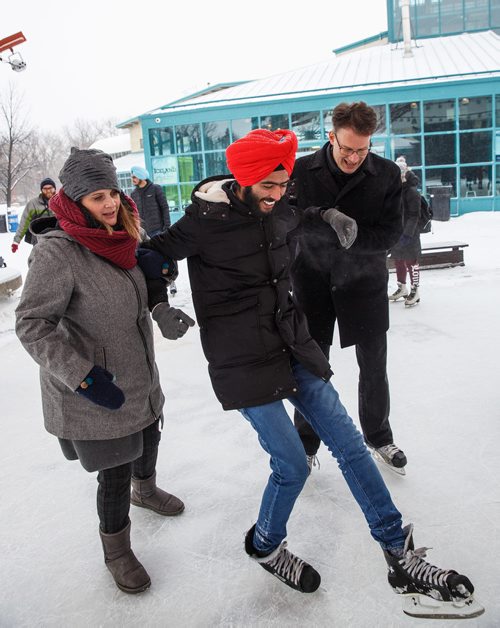 MIKE DEAL / WINNIPEG FREE PRESS
Kerry Caldwell Korabelnikov (left), director of the Language Training Centre at RRC, and Paul Vogt (right), president and CEO at RRC, help first time skater Arshdeep Singh at The Forks, Friday, February 2, 2018.
180202 - Friday, February 02, 2018.