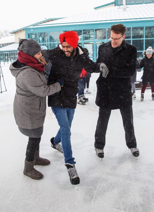 MIKE DEAL / WINNIPEG FREE PRESS
Kerry Caldwell Korabelnikov (left), director of the Language Training Centre at RRC, and Paul Vogt (right), president and CEO at RRC, help first time skater Arshdeep Singh at The Forks, Friday, February 2, 2018.
180202 - Friday, February 02, 2018.