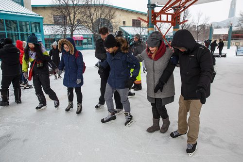 MIKE DEAL / WINNIPEG FREE PRESS
Kerry Caldwell Korabelnikov (second from right), director of the Language Training Centre at RRC helps students who are trying to skate for the first time at The Forks, Friday, February 2, 2018. The Language Training Centre at RRC brought around 30 students who had never skated before to The Forks to give them that essential Canadian experience.
180202 - Friday, February 02, 2018.