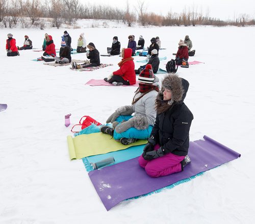 PHIL HOSSACK / Winnipeg Free Press - Dressed for a -22C session, Lindsay Waters  with her sister Mehgan (in plaid scarf) breathe in "simple seated" at Fort Whyte Alive's Fire and Ice Festival. They and about thirty other participants were taking in a session of "ice Yoga on "Lake 3" at the outdoor centre. See Solomon Isreal's story.-  February 3, 2018
