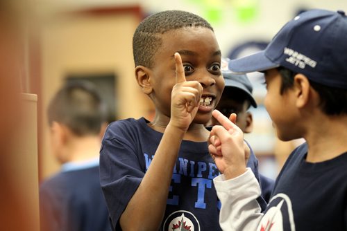 RUTH BONNEVILLE / WINNIPEG FREE PRESS


Whyte Ridge Elementary School grade 2 student, Ndanji Matibini, can't hold back his excitement while waiting in line to get Winnipeg Jets Players Bryan Little (#18) and Tyler Myers (#57) autographs  after the two Jets  read to the class  in conjunction with 'I Love to Read Month', on Monday.  Jets players visited 12 different schools throughout the city reading the official Winnipeg Jets children's storybook "Whiteout: A Winnipeg Jets Story" to classes of students from grades K to 6.

Standup photo 
February 5, 2018.
 
