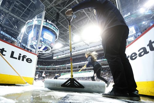 JOHN WOODS / WINNIPEG FREE PRESS
Kevin Cameron, member of the Ice Crew, keeps the entrance clear as Casey Gall skates by during first period NHL action between the Winnipeg Jets vs Arizona Coyotes in Winnipeg on Tuesday, February 6, 2018.