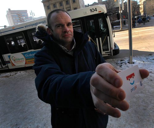 PHIL HOSSACK / Winnipeg Free Press -Scott Hazlitt and his Peggo Card pose at a downtown bus stop Wednesday. The card automatically takes a $50 payment from his credit card whenever his balance gets low. Last week the city's system glitched out and charged his account more than $11,000, (though he said $8000 +/- while I took this portrait) maxing out his credit card. -  February 7, 2018