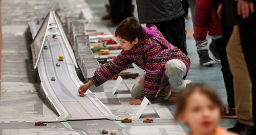 PHIL HOSSACK / Winnipeg Free Press -  8 yr old Mitzi Kenatch adjusts some of the traffic flow models on a replica of the proposed Arlington Street Bridge Thursday evening at the North Centennial Community Centre as a replica of the new bridge was put on display for the local community. See release.  -  February 8, 2018