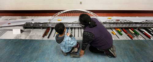 PHIL HOSSACK / Winnipeg Free Press -  Maria Abriz and her 9 yr oldson Miguel get a close look at a replica of the proposed Arlington Street Bridge Thursday evening as a replica was put on display in the North Centennial Community Centre for the local community. See release.  -  February 8, 2018