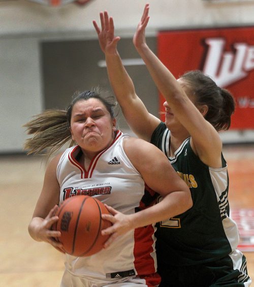 PHIL HOSSACK / Winnipeg Free Press -  U of W Wesmen's # 7 Robyn Boulanger's grimace gets her past  UNBC Timberwolf # 2 Kyla Giesbrecht Thursday evening as the teams met at the Duckworth Centre in Canada West Basketball Playoff action. -  February 8, 2018