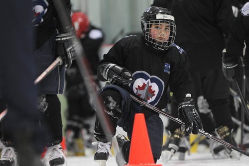 RUTH BONNEVILLE / WINNIPEG FREE 

49.8 TNYF feature.  Grade 4/5 students from Crestview School learn to play hockey on ice with Murray Cobb, Director, Winnipeg Jets Hockey Academy and volunteers at Iceplex Tuesday.  Story on the 12th year, the Winnipeg Jets Hockey Academy's  play-based program that is designed to increase school attendance and high school graduation rates, and instill life skills through the game of hockey. 
 Students name - Edan.

See Randy Turner story.
Feb 09/18