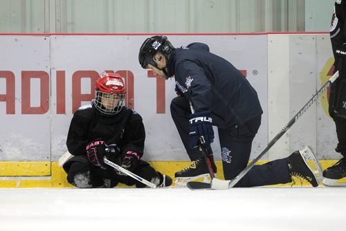 RUTH BONNEVILLE / WINNIPEG FREE 

49.8 TNYF feature.  Grade 4/5 students from Crestview School learn to play hockey on ice with Murray Cobb, Director, Winnipeg Jets Hockey Academy and volunteers at Iceplex Tuesday.  Story on the 12th year, the Winnipeg Jets Hockey Academy's  play-based program that is designed to increase school attendance and high school graduation rates, and instill life skills through the game of hockey. 
 Photo of Murray Cobb, Director, Winnipeg Jets Hockey Academy working with student, Jennifer, on ice.  

See Randy Turner story.
Feb 09/18