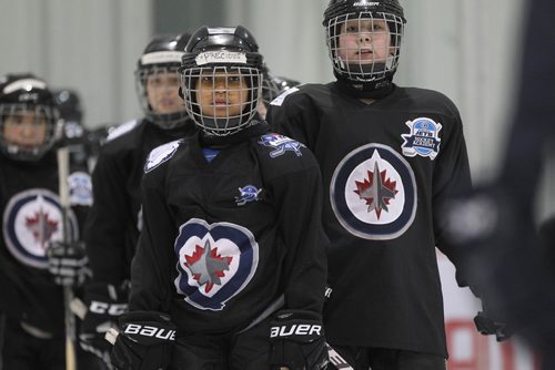 RUTH BONNEVILLE / WINNIPEG FREE 

49.8 TNYF feature.  Grade 4/5 students from Crestview School learn to play hockey on ice with Murray Cobb, Director, Winnipeg Jets Hockey Academy and volunteers at Iceplex Tuesday.  Story on the 12th year, the Winnipeg Jets Hockey Academy's  play-based program that is designed to increase school attendance and high school graduation rates, and instill life skills through the game of hockey. 
 Precious on ice with fellow classmates. 

See Randy Turner story.
Feb 09/18