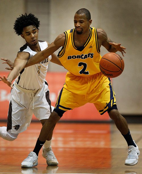 PHIL HOSSACK / Winnipeg Free Press - U of M Bison #1 Keiran Zziwa tangles with  Brandon Bobcat #2 Tyvon Cooper Friday night at the Investor's Group SAthletic Centre.  -  February 9, 2018