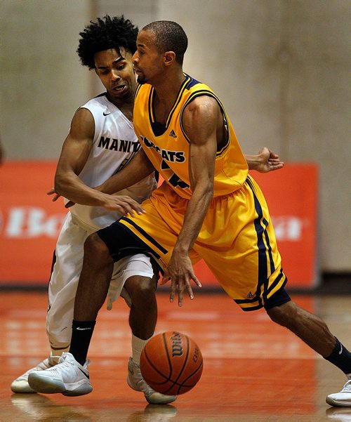 PHIL HOSSACK / Winnipeg Free Press - U of M Bison #1 Keiran Zziwa tangles with  Brandon Bobcat #2 Tyvon Cooper Friday night at the Investor's Group Athletic Centre.  -  February 9, 2018