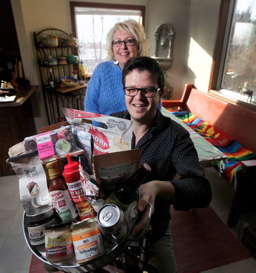 PHIL HOSSACK / Winnipeg Free Press - Peter Fehr of Gourmet Inspirations, and Sherry Sobey pose with a basket full of local goodies. See Wendy King's story re: Love Local Manitoba Event. -  February 10, 2018