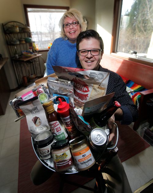 PHIL HOSSACK / Winnipeg Free Press - Peter Fehr of Gourmet Inspirations, and Sherry Sobey pose with a basket full of local goodies. See Wendy King's story re: Love Local Manitoba Event. -  February 10, 2018