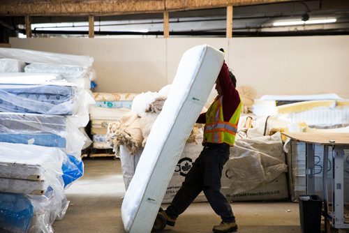 MIKAELA MACKENZIE / WINNIPEG FREE PRESS
Warren Ostifichuk manhandles a mattress before stripping it down at the Mother Earth Recycling centre in Winnipeg, Manitoba on Monday, Feb. 12, 2018. The centre recycles things like electronics and mattresses, but also offers jobs and training to low income people to help get them on their feet.
180212 - Monday, February 12, 2018.