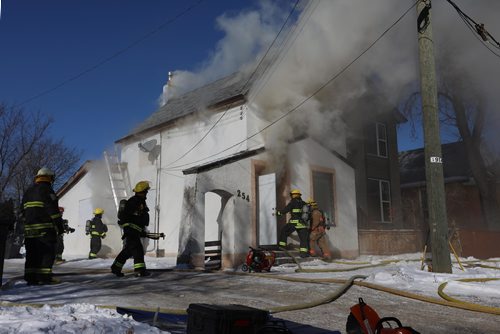 RUTH BONNEVILLE / WINNIPEG FREE 

Fire crews work to put out a fire at 245 Lulu Monday afternoon.  
Standup photo 
FEB 12, 2018