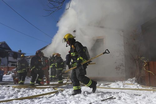 RUTH BONNEVILLE / WINNIPEG FREE 

Fire crews work to put out a fire at 245 Lulu Monday afternoon.  
Standup photo 
FEB 12, 2018