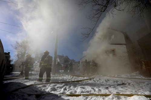 RUTH BONNEVILLE / WINNIPEG FREE 

Fire crews work to put out a fire at 245 Lulu Monday afternoon.  
Standup photo 
FEB 12, 2018