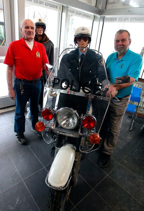 BORIS MINKEVICH / WINNIPEG FREE PRESS
The Winnipeg Police Museum at the new Police Headquarters. From left, Police historians Jack Templeman and Randy James pose for a photo in the museum with an old police motorcycle. BILL REDEKOP STORY Feb. 13, 2018