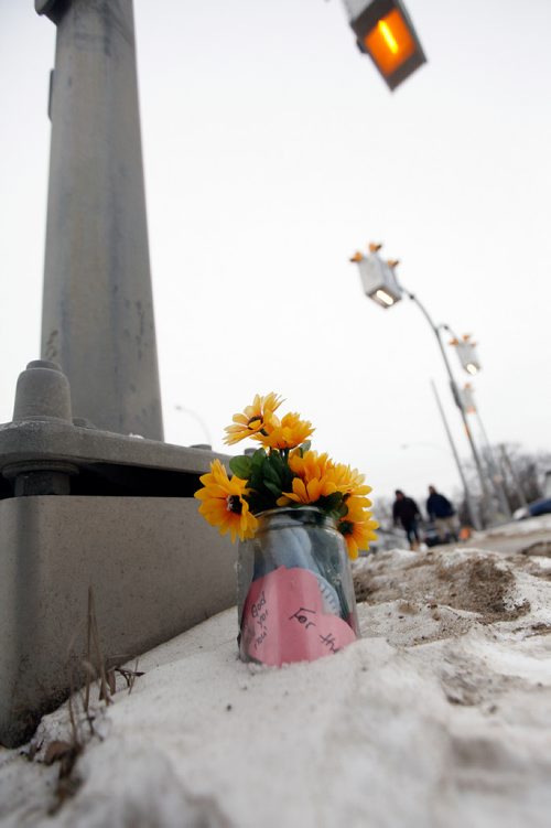 PHIL HOSSACK / WINNIPEG FREE PRESS - At a crosswalk a small bouquet serves as memorial at the scene of a young boy's death at Varennes ave and St Annes Rd Tuesday afternoon. See story. February 13, 2018